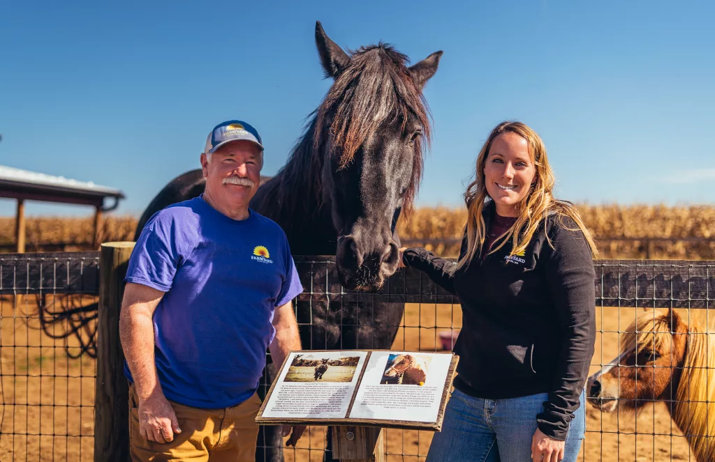 Father and Daughter pose with pet horse